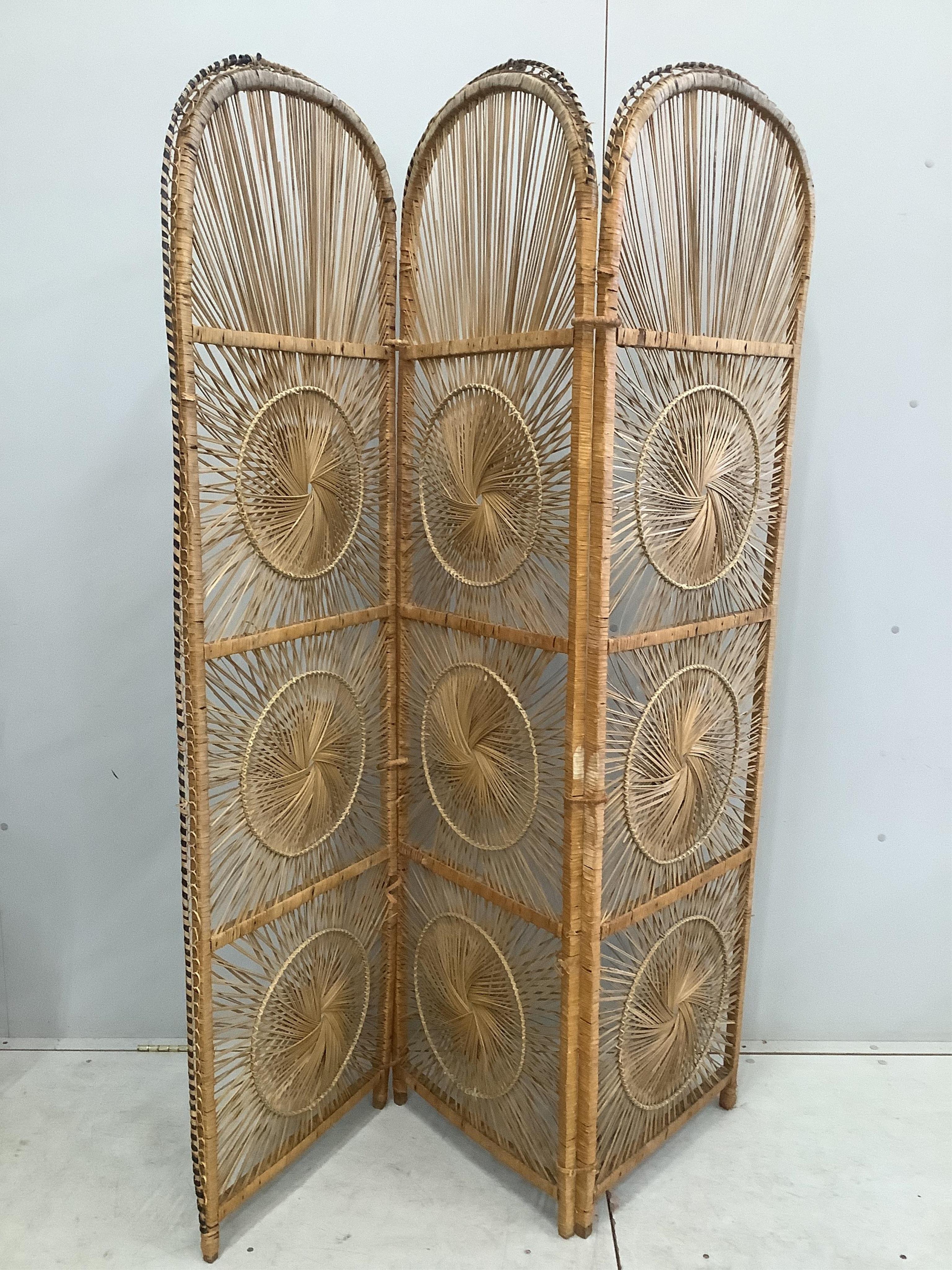 A rattan elbow chair, width 82cm, height 130cm together with a three fold screen